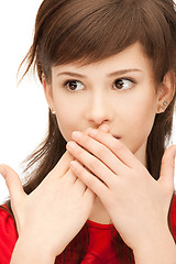 Image showing teenage girl with palms over mouth