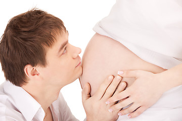 Image showing male face and pregnant woman belly