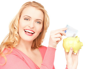 Image showing lovely woman with piggy bank and money