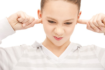 Image showing teenage girl with fingers in ears