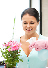 Image showing lovely housewife with flower