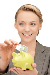 Image showing lovely woman with piggy bank and money