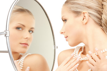 Image showing beautiful woman with pearl beads and mirror