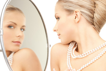 Image showing beautiful woman with pearl beads and mirror