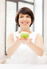 Image showing lovely housewife with green apple