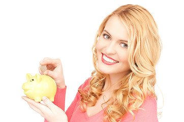 Image showing lovely woman with piggy bank and money