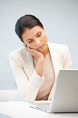 Image showing pensive woman with laptop computer
