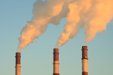 Image showing Three smoking chimneys