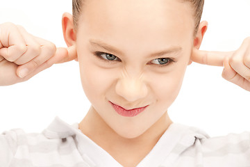 Image showing teenage girl with fingers in ears