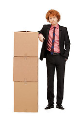 Image showing attractive businessman with big boxes