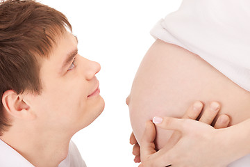 Image showing male face and pregnant woman belly