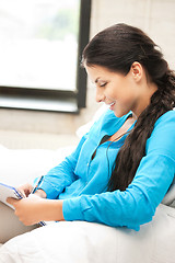 Image showing happy woman with big notepad