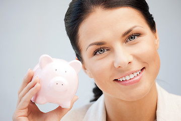 Image showing lovely woman with piggy bank