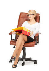 Image showing young businesswoman with folders sitting in chair