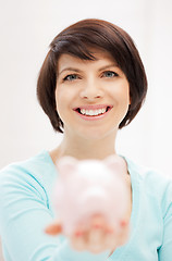 Image showing lovely woman with piggy bank