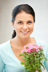 Image showing lovely housewife with flower