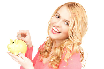 Image showing lovely woman with piggy bank and money