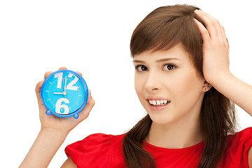 Image showing teenage girl holding alarm clock