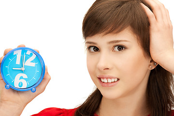 Image showing teenage girl holding alarm clock