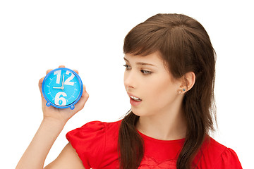 Image showing teenage girl holding alarm clock