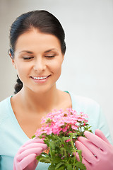 Image showing lovely housewife with flower