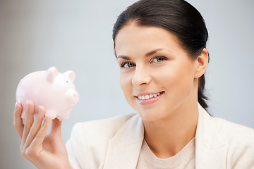 Image showing lovely woman with piggy bank