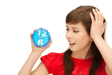 Image showing teenage girl holding alarm clock