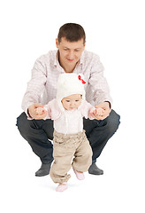 Image showing baby making first steps with father help