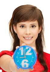 Image showing teenage girl holding alarm clock