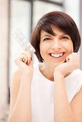 Image showing young beautiful woman with pills