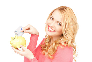 Image showing lovely woman with piggy bank and money