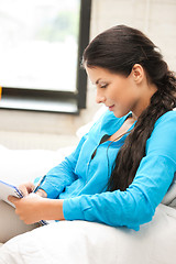 Image showing calm woman with big notepad