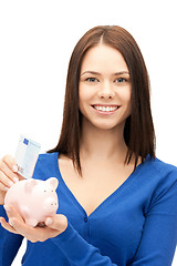 Image showing lovely woman with piggy bank and money