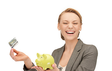 Image showing lovely woman with piggy bank and money