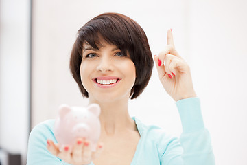 Image showing lovely woman with piggy bank