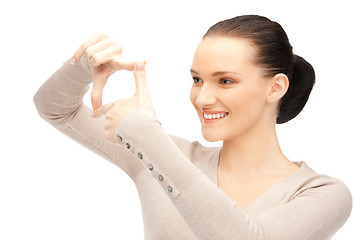 Image showing lovely woman creating a frame with fingers