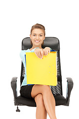 Image showing young businesswoman with folders sitting in chair