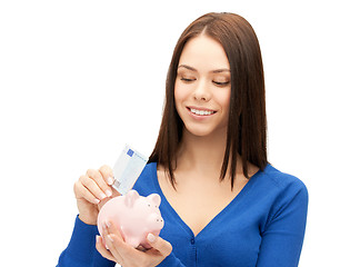 Image showing lovely woman with piggy bank and money