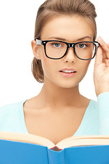 Image showing calm and serious woman with book