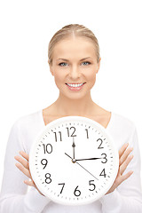 Image showing woman holding big clock