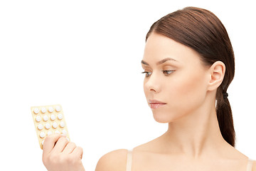 Image showing young beautiful woman with pills