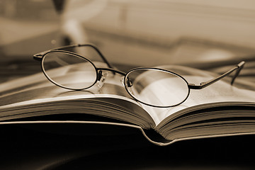 Image showing Close up on the Glasses and the Magazine