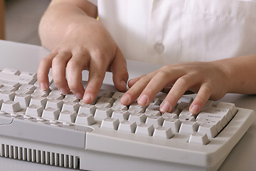 Image showing Little fingers typing