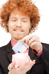 Image showing man with piggy bank and money