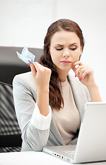 Image showing pensive woman with computer and euro cash money