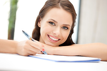 Image showing happy woman with big notepad