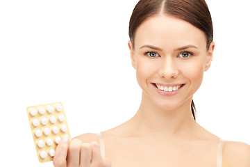 Image showing young beautiful woman with pills