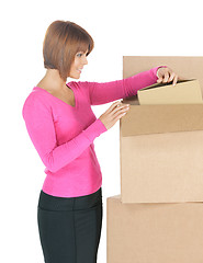 Image showing attractive businesswoman with big boxes