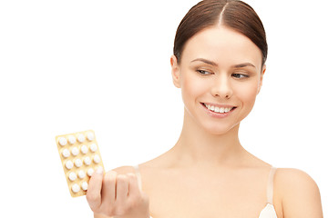 Image showing young beautiful woman with pills