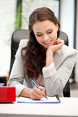Image showing happy woman with big notepad